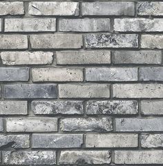 a brick wall that is made out of grey bricks