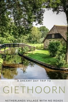 a small house sitting on top of a lush green field next to a river with a bridge