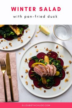 two white plates topped with meat and veggies on top of a pink table cloth