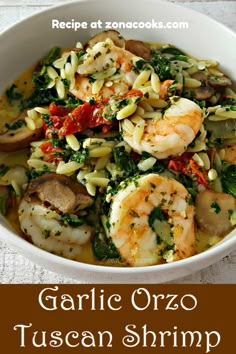 garlic orzo pasta with shrimp and spinach in a white bowl