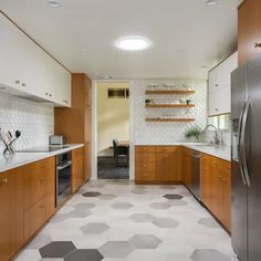 a kitchen with wooden cabinets and stainless steel appliances