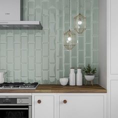 a kitchen with white cabinets and green tile backsplashing on the back wall