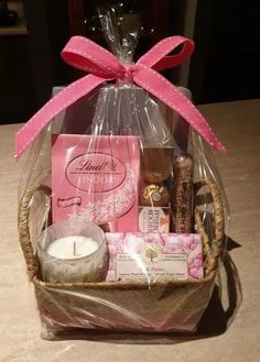 a basket filled with lots of goodies on top of a table next to a candle