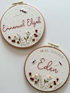 two embroidered hoops with words and flowers on them