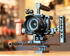 a camera sitting on top of a wooden table next to a cork and metal object