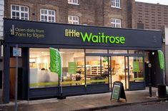 a storefront with the words waitrose on it's front window and outside