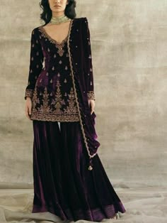 Beautiful short embroidered velvet kurti with flair velvet sharara is perfect for winter wedding and festival. Elegant plum colour velvet sharara suit  🌸KURTA This beautiful velvet kurti has zari,beads embroidery over the neck, sleeves and hem line. It has small motifs all over the front BOTTOM Flair velvet garara with crepe lining 🌸Lace dupatta The dupatta will have lace border on all for side, and the fabric will be orgenza.  🌸Embroidery dupatta For this the dupatta will be of velvet fabric with same beads handwork as in the picture.  👉please check the dupatta description before making purchase.  ✨If you want any changes in the outfit please contact us we will guide you as per your preference.  ✨We assure you that we use only high quality fabric and threads to make any dress and you Velvet Sharara Suit, Velvet Sharara, Sureena Chowdhri, Gharara Designs, Velvet Suit Design, Velvet Kurta, Sharara Designs, Velvet Dress Designs, Salwar Kamiz