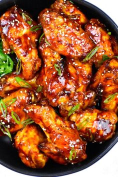 chicken wings with sesame seeds in a black bowl