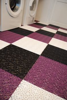 a washer and dryer sitting on top of a checkered floor next to each other