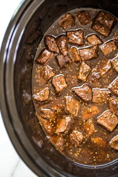 the meat is being cooked in the slow cooker