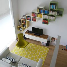 a living room filled with furniture and bookshelves next to a flat screen tv