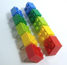 four lego pieces are arranged in rainbow colors