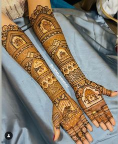 two hands with henna designs on them