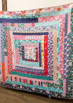 a large colorful quilt is on the floor