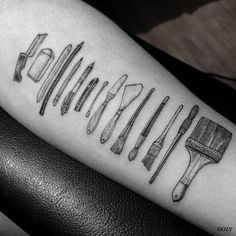 a black and white photo of a tattoo with different tools on it's arm