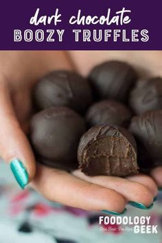 someone holding some chocolate truffles in their hands with the words, dark chocolate boozy truffles