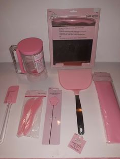 pink kitchen utensils are sitting on the counter