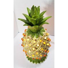 a decorative pineapple shaped vase with lights on it