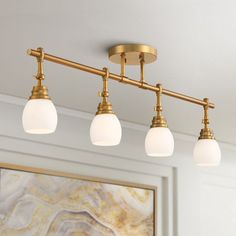 an image of a bathroom light fixture with three lights on it's side and a marble wall in the background