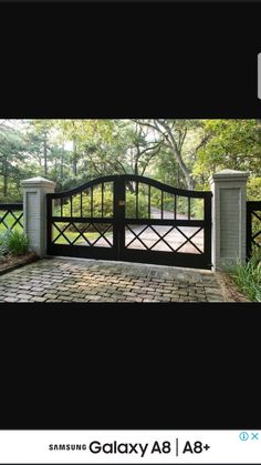 an image of a gate in the middle of a driveway