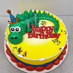 a birthday cake with a green dragon on it