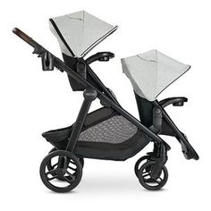 two baby strollers sitting next to each other on a white background, one is black and the other is grey