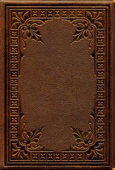 a brown leather book with an ornate design