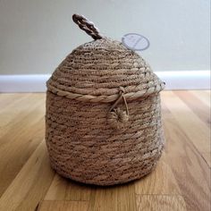 a large woven basket sitting on top of a wooden floor