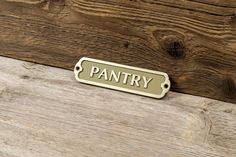 a sign that says pantry on the side of a wooden wall with wood planks