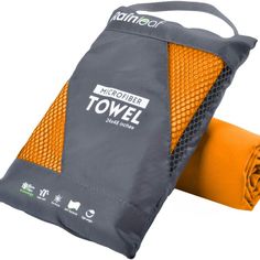 an orange and gray towel sitting on top of a bag next to it's cover