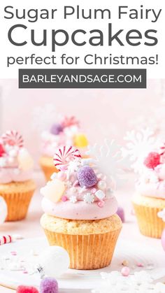 cupcakes with pink frosting and sprinkles on top are sitting on a plate