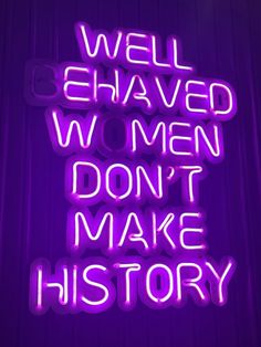 neon sign that says well behaved women don't make history