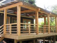 a house with wooden decking and railings