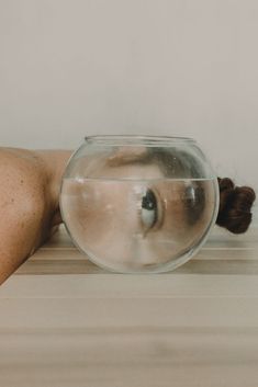 an instagram photo of a woman's back and her fish bowl