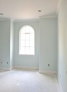 empty room with light blue walls and white carpet