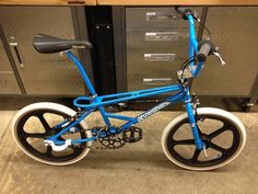 a blue bicycle parked in front of a filing cabinet