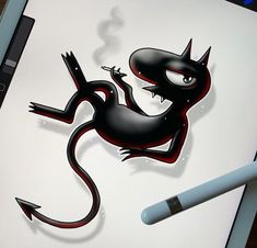 a drawing of a black and red lizard on a white paper with a pen next to it