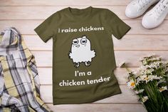 Introducing our playful "I Raise Chickens, I'm a Chicken Tender" t-shirt, the perfect blend of humor and pride for chicken enthusiasts! This fun tee celebrates the joys of raising your own flock while adding a light-hearted twist. Made from soft, high-quality cotton, it offers all-day comfort whether you're tending to your chickens or enjoying a casual outing. The witty design features bold, eye-catching lettering that is sure to spark smiles and conversations among fellow chicken lovers. This shirt is an excellent way to showcase your passion for poultry, making it a fantastic gift for farmers, backyard chicken keepers, or anyone who appreciates a good pun. Available in a variety of sizes and colors, this t-shirt is perfect for farm visits, chicken-themed events, or simply lounging at hom Chicken Tender, Raise Chickens, Farmer Shirt, Best Puns, Funny Chicken, Gifts For Farmers, Chicken Humor, Chicken Lovers, A Chicken