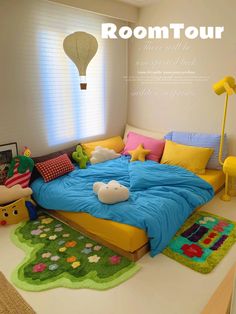 the room is decorated in bright colors and has a bed with pillows, rugs, and a hot air balloon