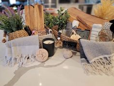 a table topped with lots of different types of towels and other items on top of it