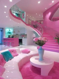 a living room filled with furniture and pink carpeted flooring next to a spiral staircase