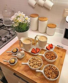 a kitchen counter with bowls and spoons filled with food