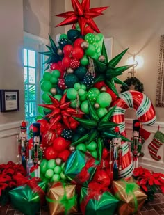 a christmas tree decorated with green and red balls, candy canes and star decorations