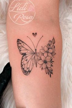 a woman's thigh with a butterfly and flowers tattoo on the side of her leg