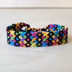 a multicolored bracelet on a white surface