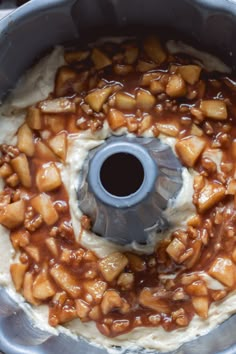 a food processor filled with mashed potatoes covered in caramel sauce and toppings