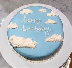 a light blue cake that spells out “happy birthday” and is decorated with fluffy white clouds Blue Cake With Clouds, Light Blue Cake Birthday, Light Blue Birthday Cake, Cloud Birthday Cake, Cloud Cake Decoration, Best Birthday Cake Designs, Boys First Birthday Cake, Blue Birthday Cakes, Minimalist Birthday