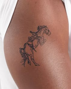 a person with a horse tattoo on their arm