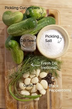 the ingredients for pickles are displayed on a cutting board, including cucumbers, salt, fresh dill, garlic and garlic