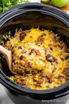 the crock pot is filled with taco meat and black beans